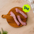 A pile of Birmingham Raw duck neck dog treats sold by the kilogram, displayed on a round wooden cutting board over a light wood kitchen unit.